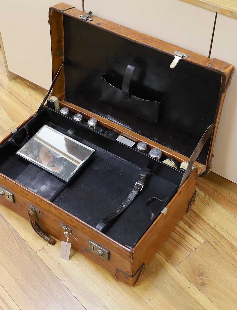 A Dupont travel suitcase, initialled ‘L.C.’ with French white metal mounted bottles